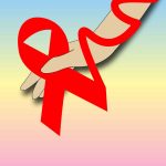 A hand with a red ribbon tied along the fingers and wrist.